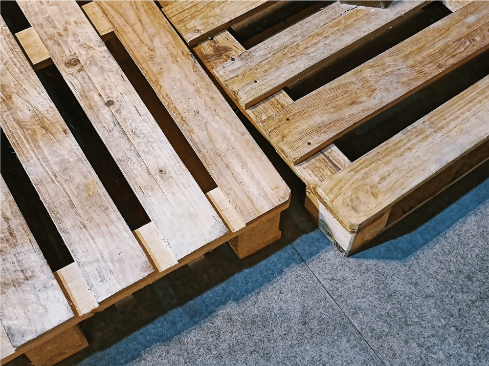 Due pallet di legno su pavimento grigio.